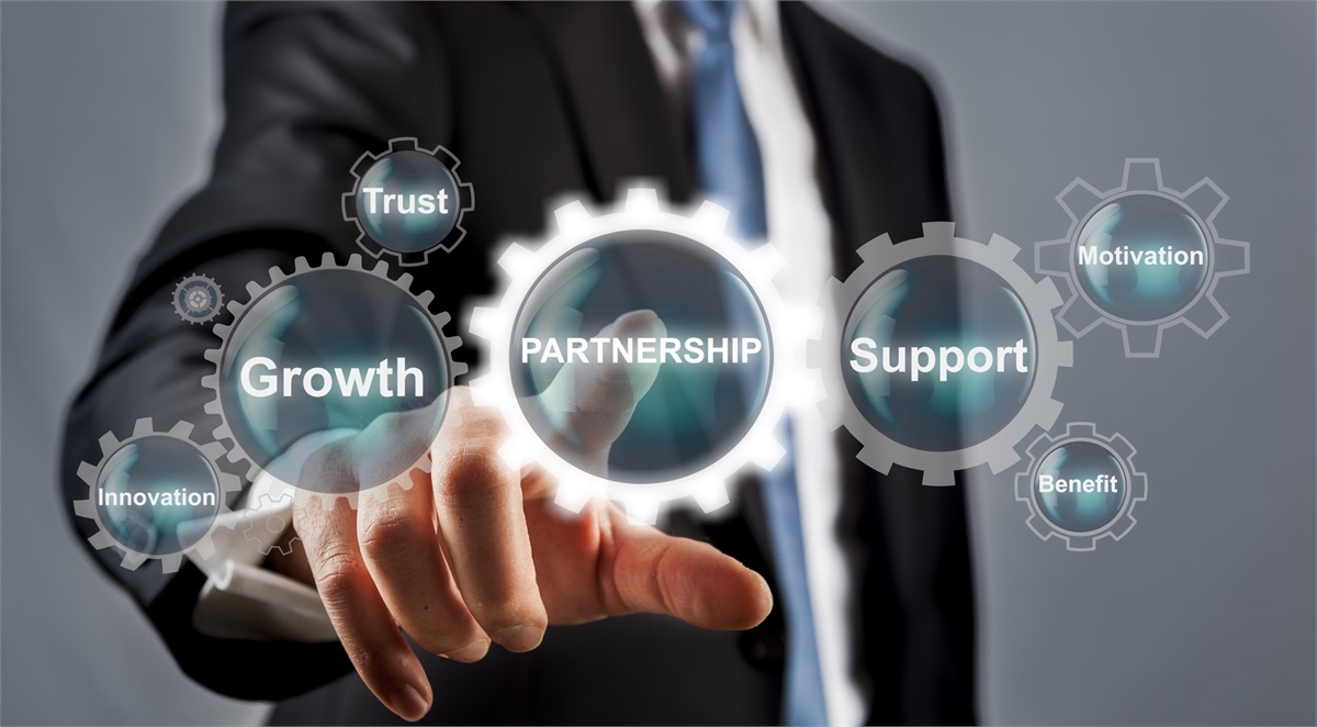 Multiple text signs inside small gear icon circles showing growth, trust, partnership, 
                    support, motivation, and benefit. A person in a business suit touching partnership text.